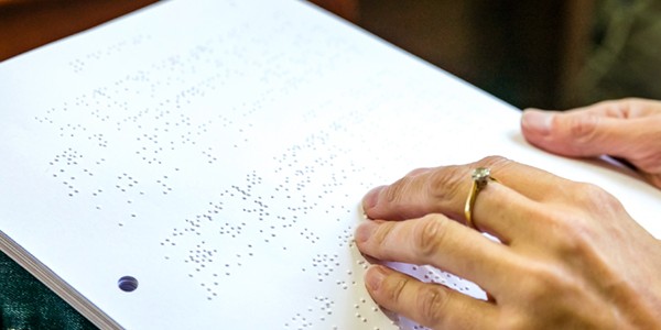 customer reading braille