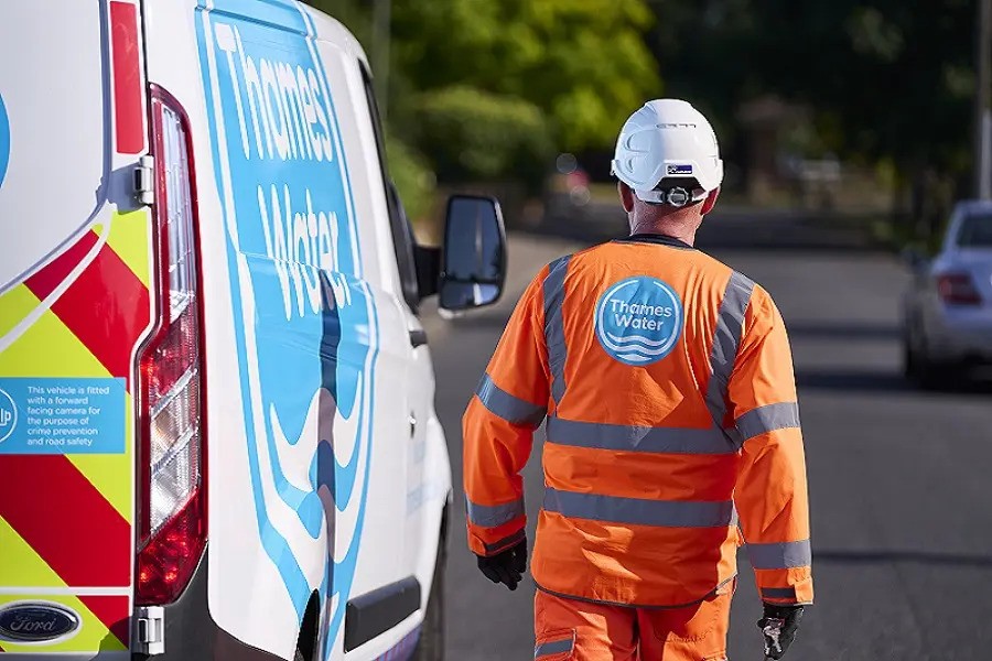 Thames Water engineer walking in front of van